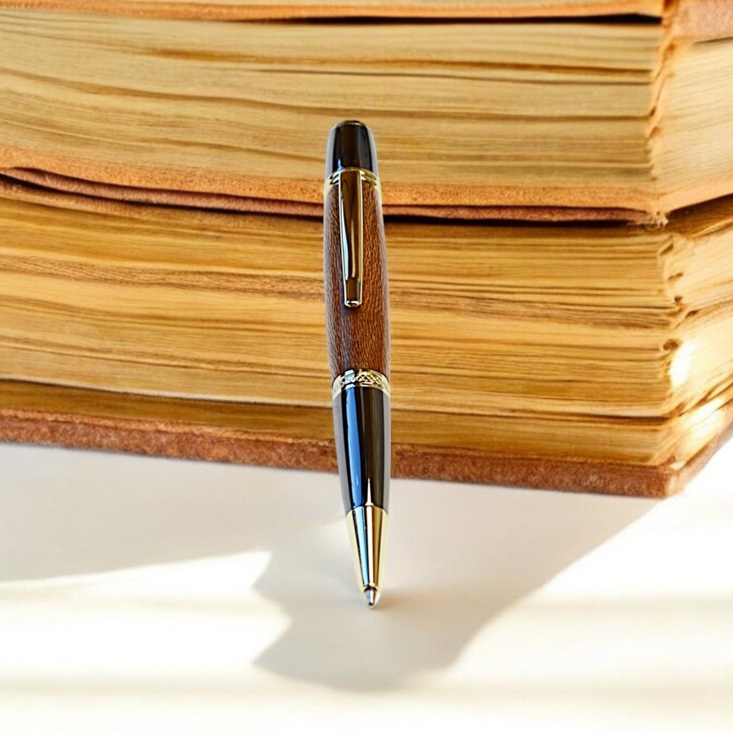 Handmade Irish ballpoint pen crafted from English Plane wood with Gold and Black Titanium trim – inspired by the Book of Kells"