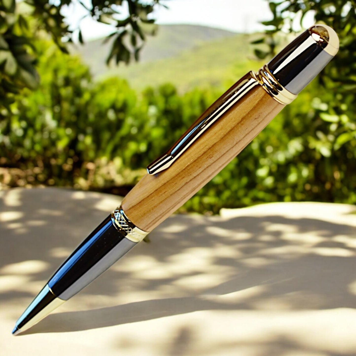 Handmade Olive Wood Ballpoint Pen with gold and black titanium trim, crafted in Ireland by Irish Pens