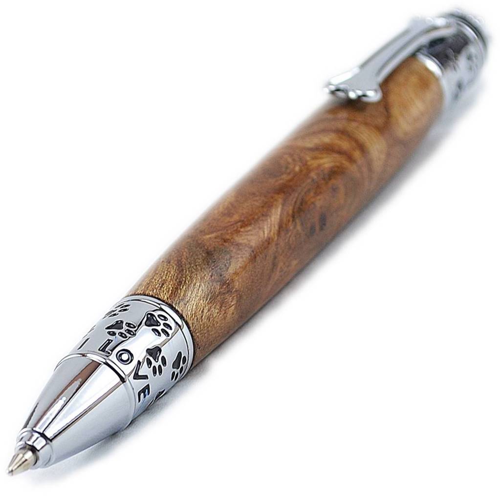 Close-up of paw print and bone motif dog-themed trim on handcrafted ballpoint pen