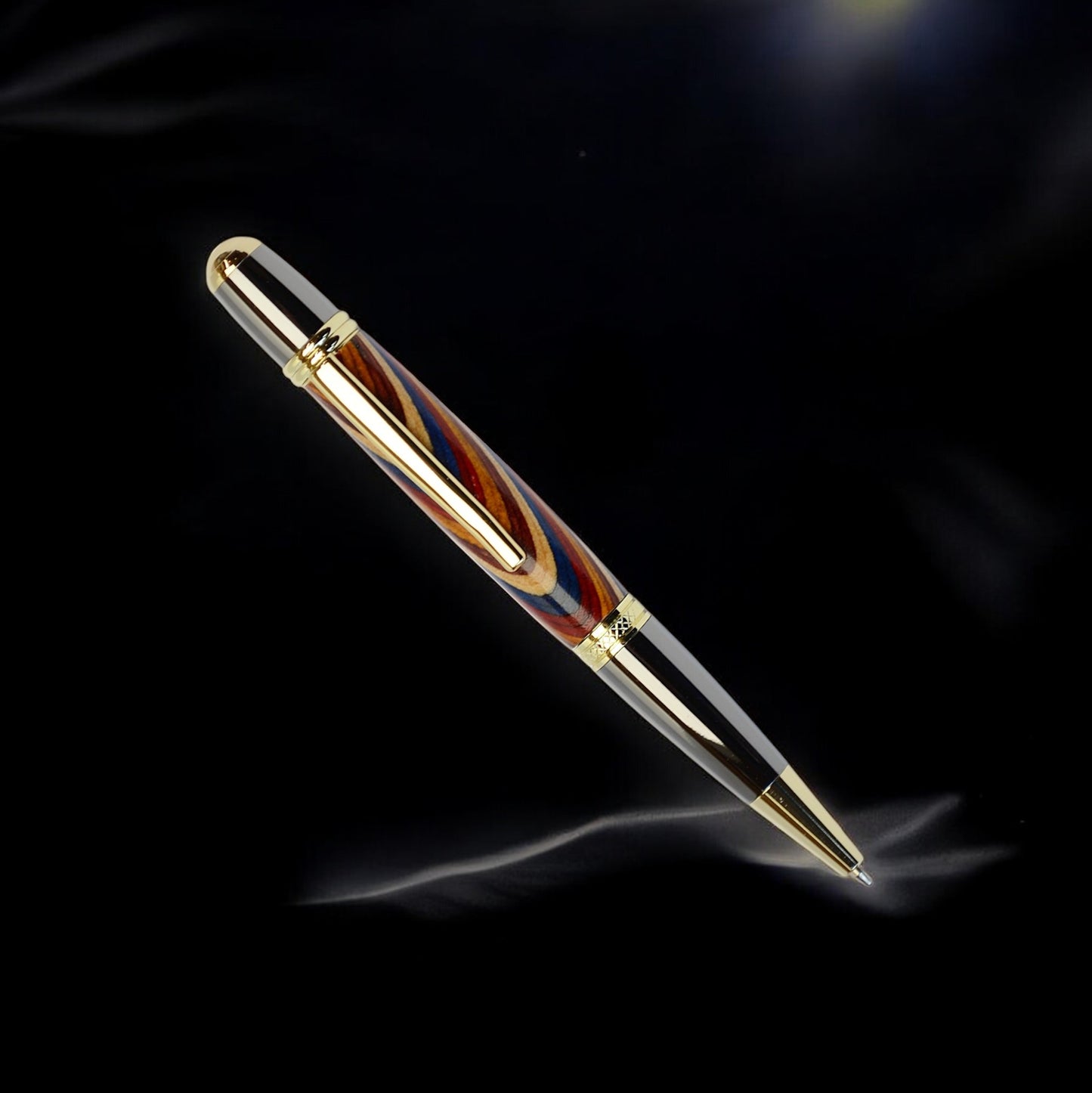 Handcrafted Rainbow Wood ballpoint pen with gold and black titanium trim, handmade in Ireland and presented in a luxury gift box