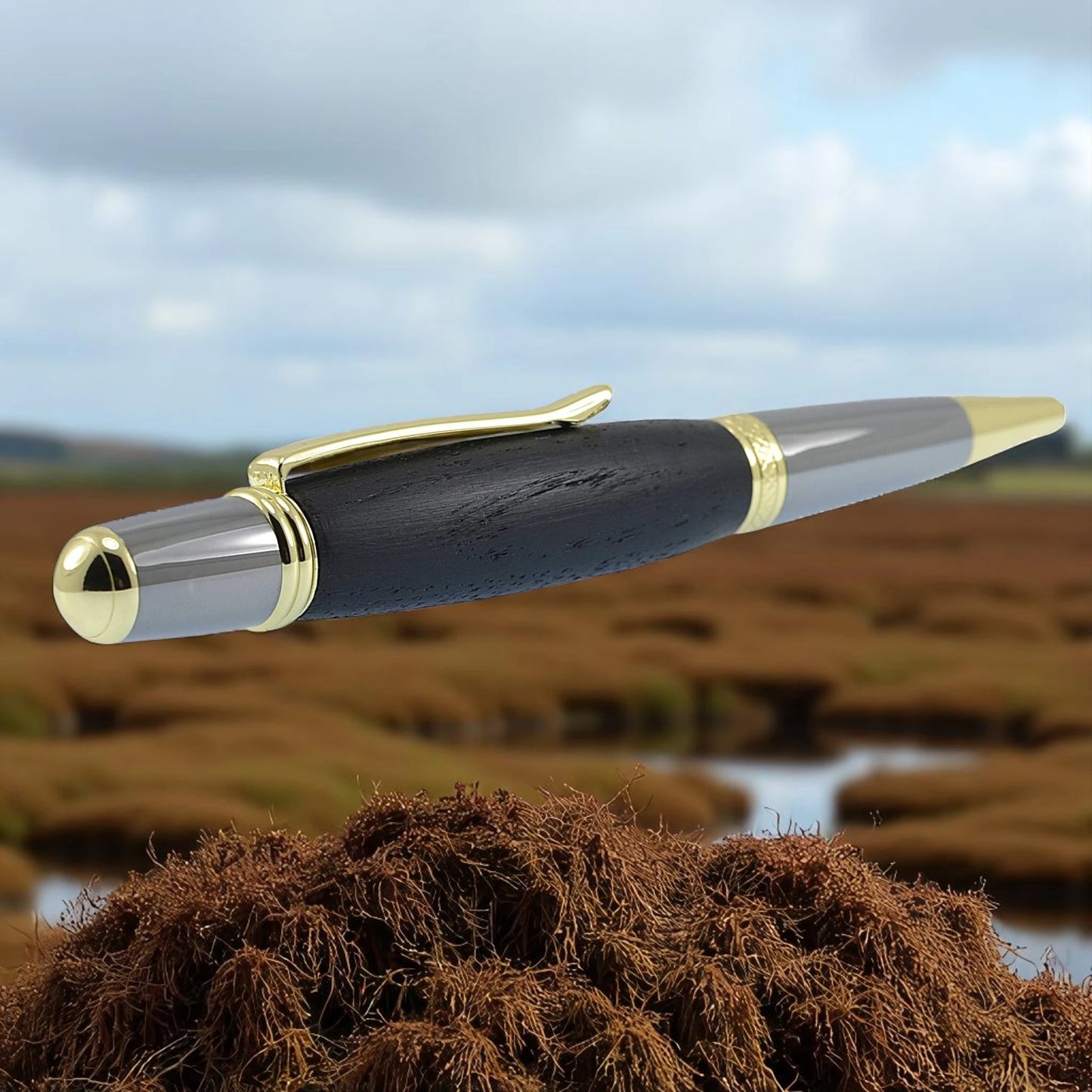 Handmade Irish Bog Oak ballpoint pen with gold and black titanium trim – crafted in Ireland