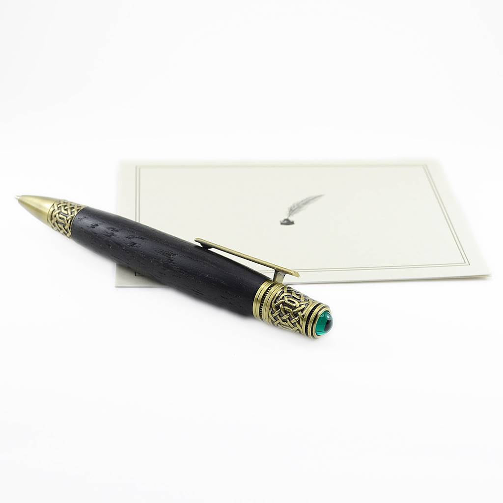 Celtic Knot Irish Bog Oak ballpoint pen with antique brass trim and emerald cabochon