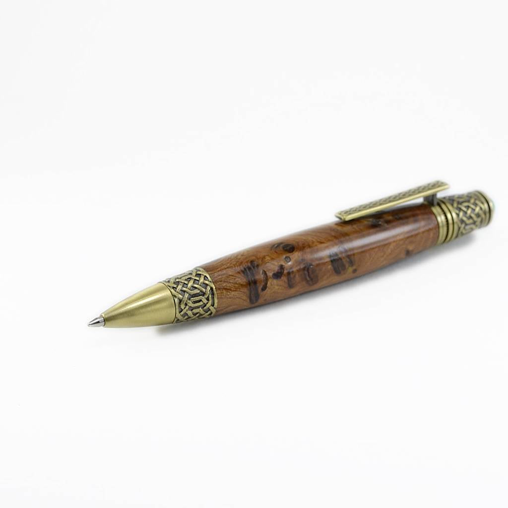 Handcrafted Celtic Knot pen made from rare Burled Irish Elm with antique brass detailing and emerald cabochon – presented in a luxury Irish pen case