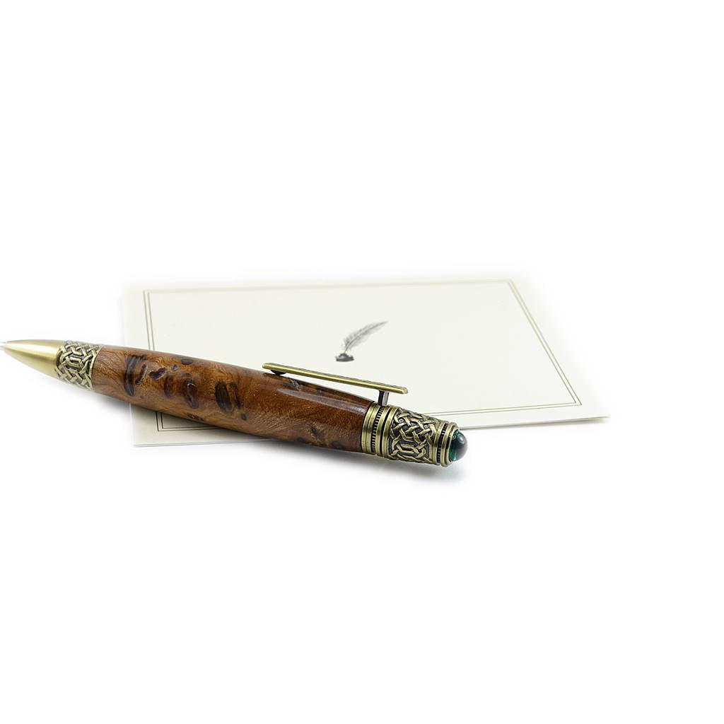 Handcrafted Celtic Knot pen made from rare Burled Irish Elm with antique brass detailing and emerald cabochon – presented in a luxury Irish pen case