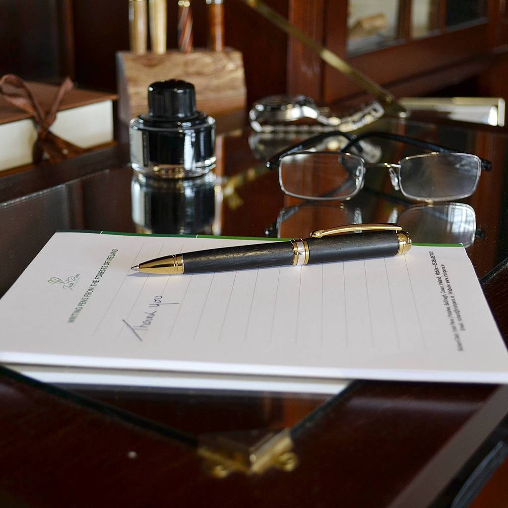 Handcrafted Irish Bog Oak ballpoint pen with gold titanium and rhodium trim
